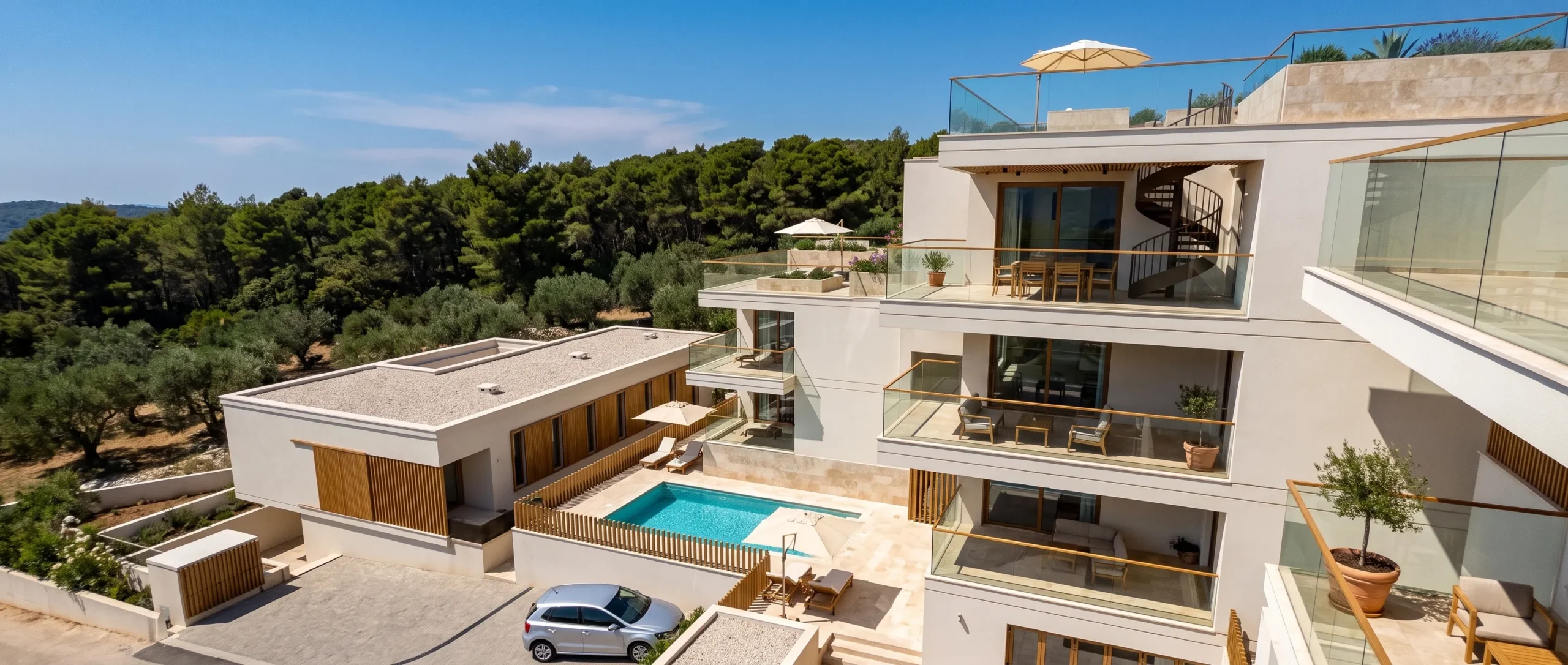 Rooftop terrace and private pool beside an apartment building, pine hillside behind